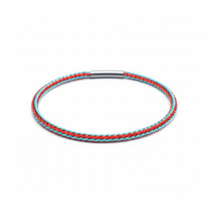 Braided bracelet with red and turquoise pattern on white background