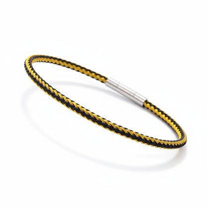 Gold and black braided bracelet on white background