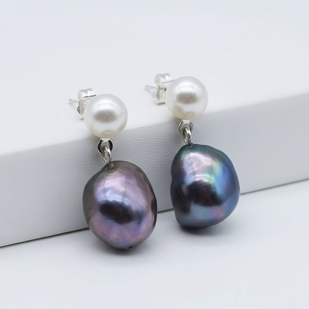 Pearl drop earrings on white background